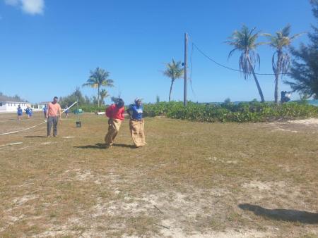 A few high school students compete in a sack race at Camp Abaco during the 2022-2023 Spiritual Emphasis Week.