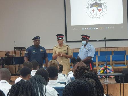 Members of the police force speak to the students during a chapel service.