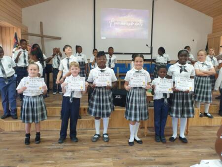 Elementary students earn Reader of the Month certificates.